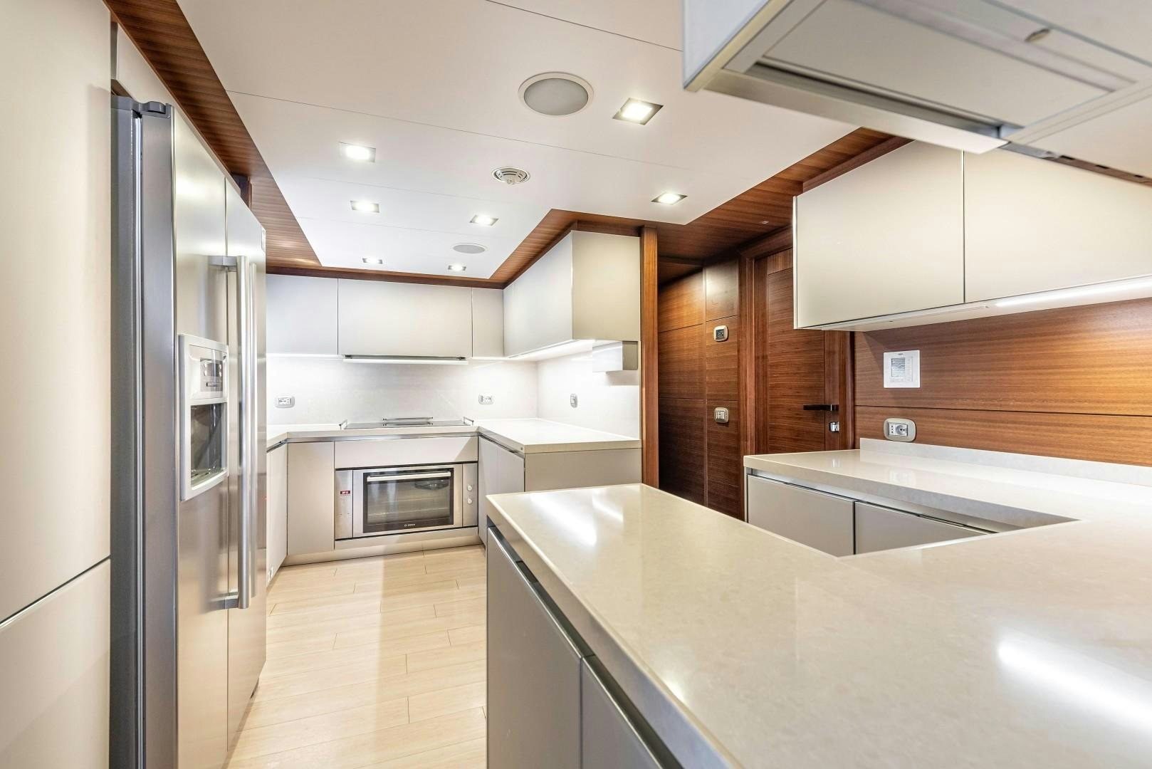 a kitchen with a refrigerator and microwave aboard ARGENTO Yacht for Sale