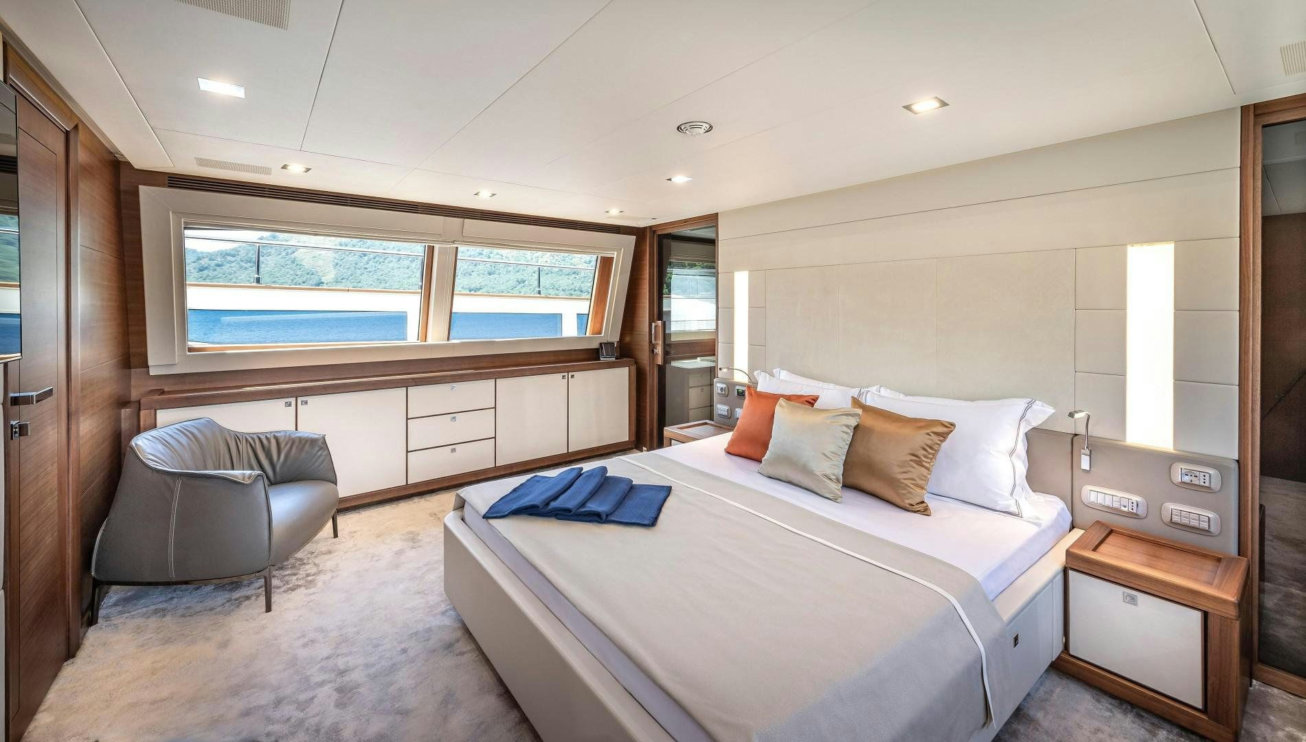 a bed and chair in a room aboard ARGENTO Yacht for Sale