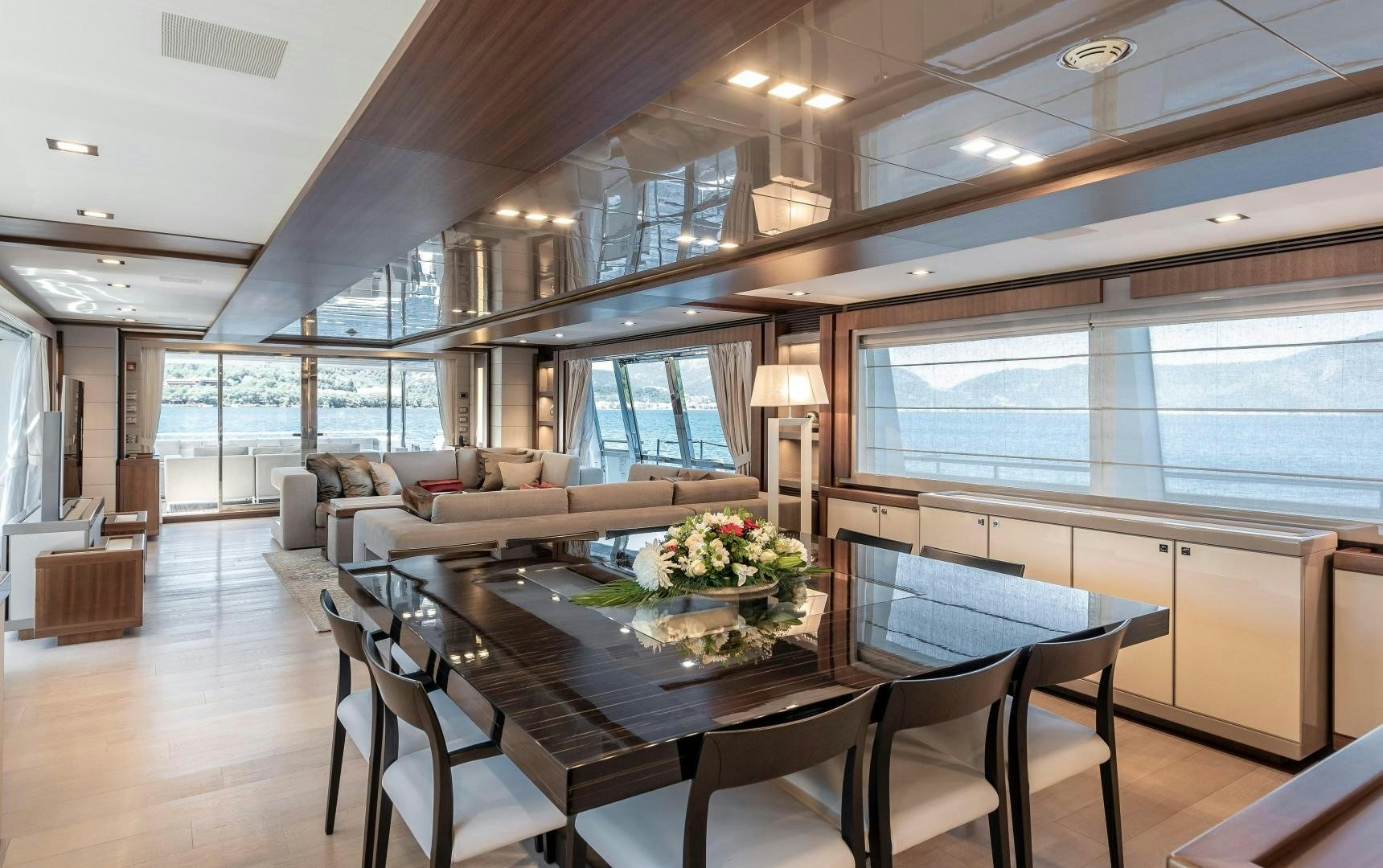 a large living room with a large table and chairs aboard ARGENTO Yacht for Sale