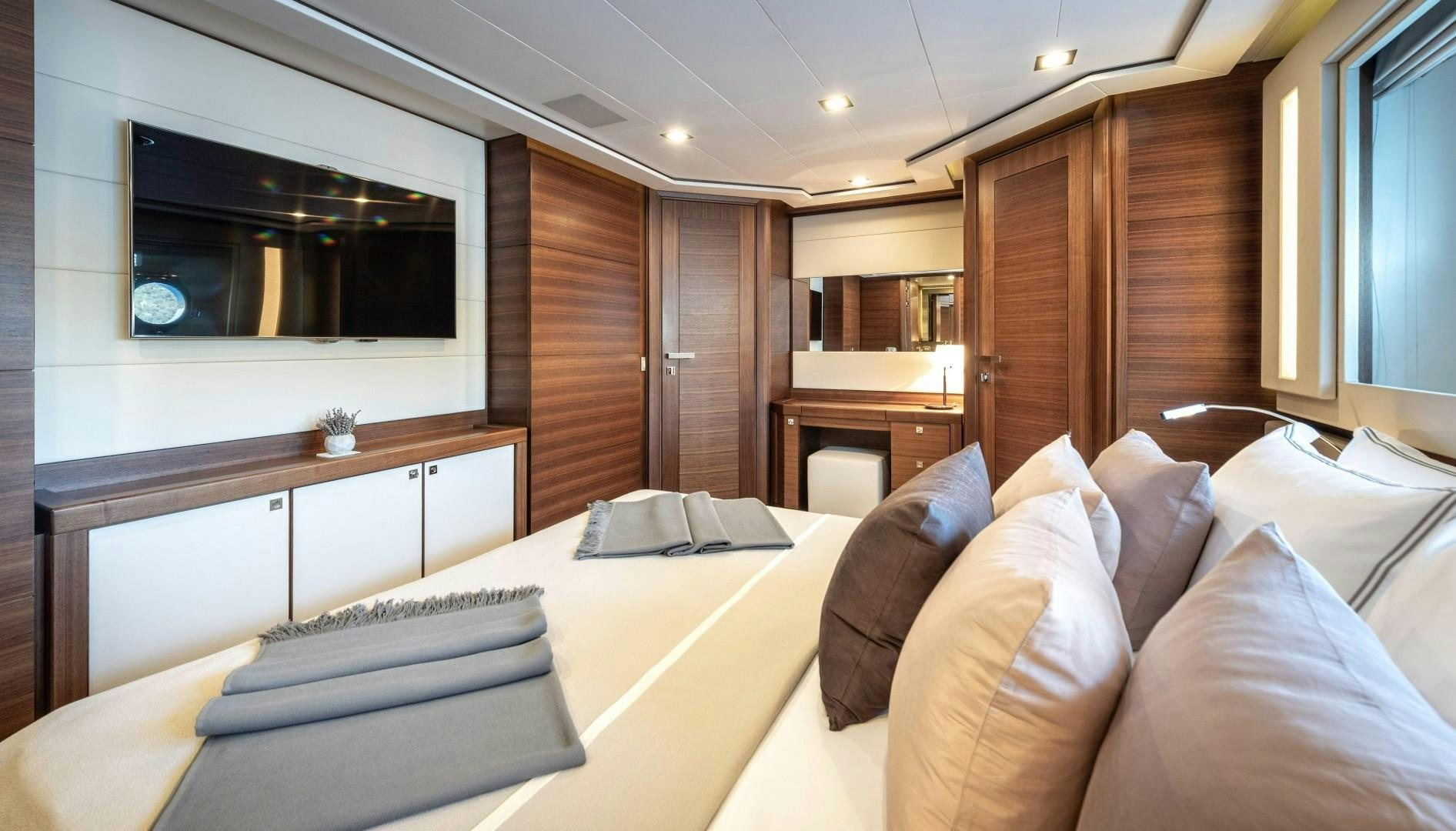 a room with a bed and a couch aboard ARGENTO Yacht for Sale