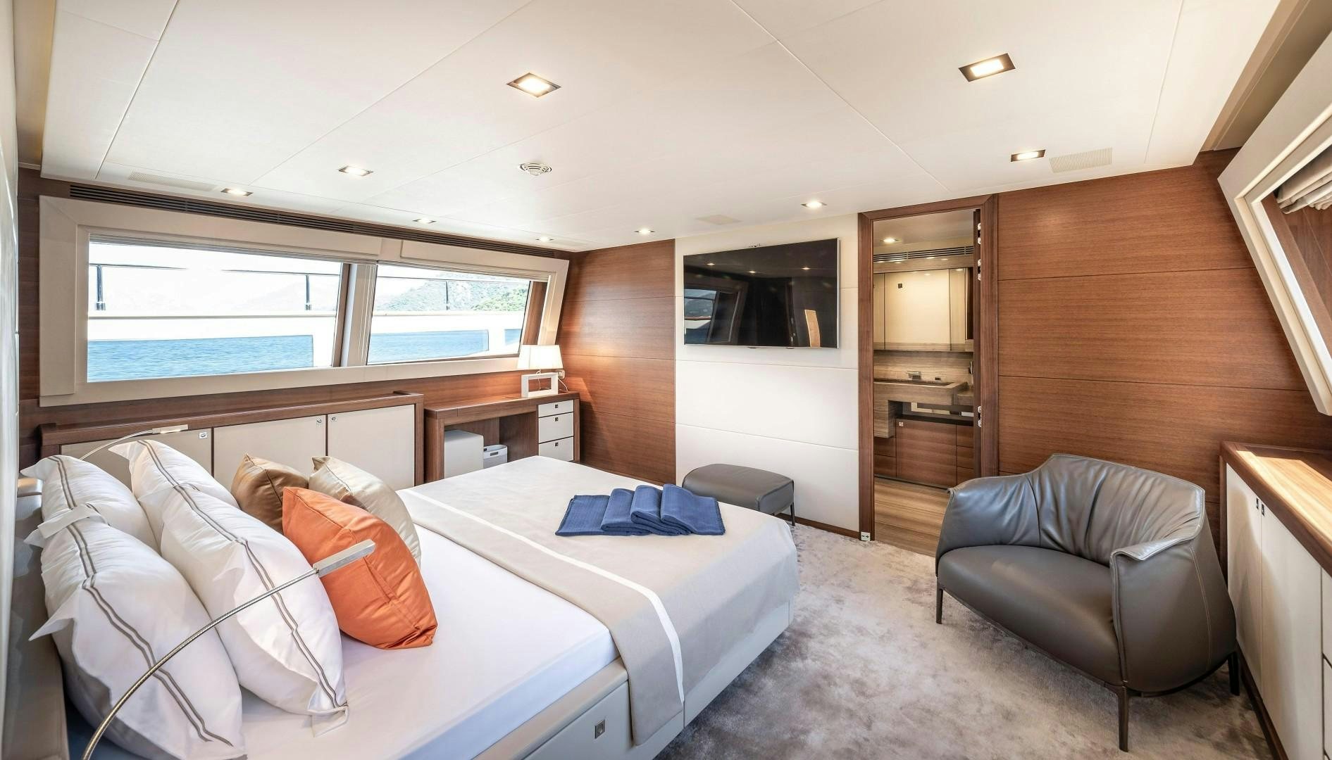 a room with a bed and a chair aboard ARGENTO Yacht for Sale