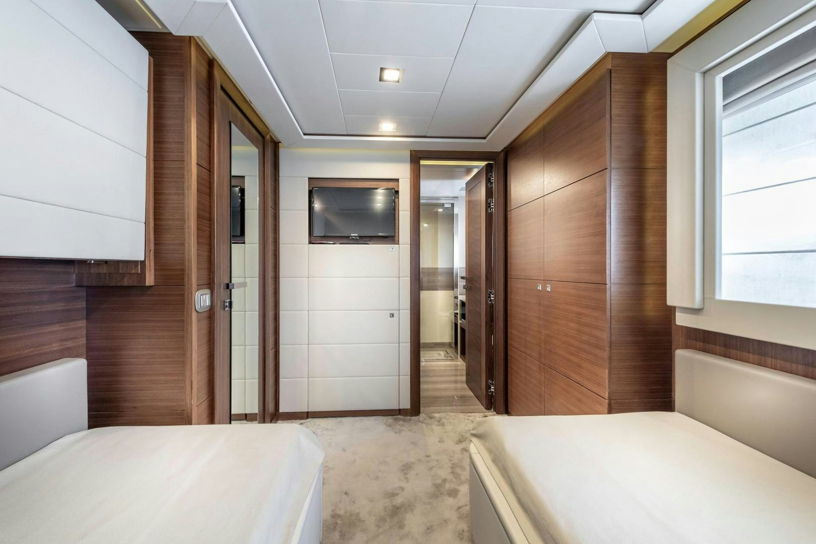 a room with a bed and a television aboard ARGENTO Yacht for Sale