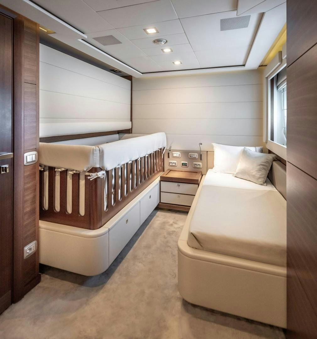 a room with a couple of beds aboard ARGENTO Yacht for Sale
