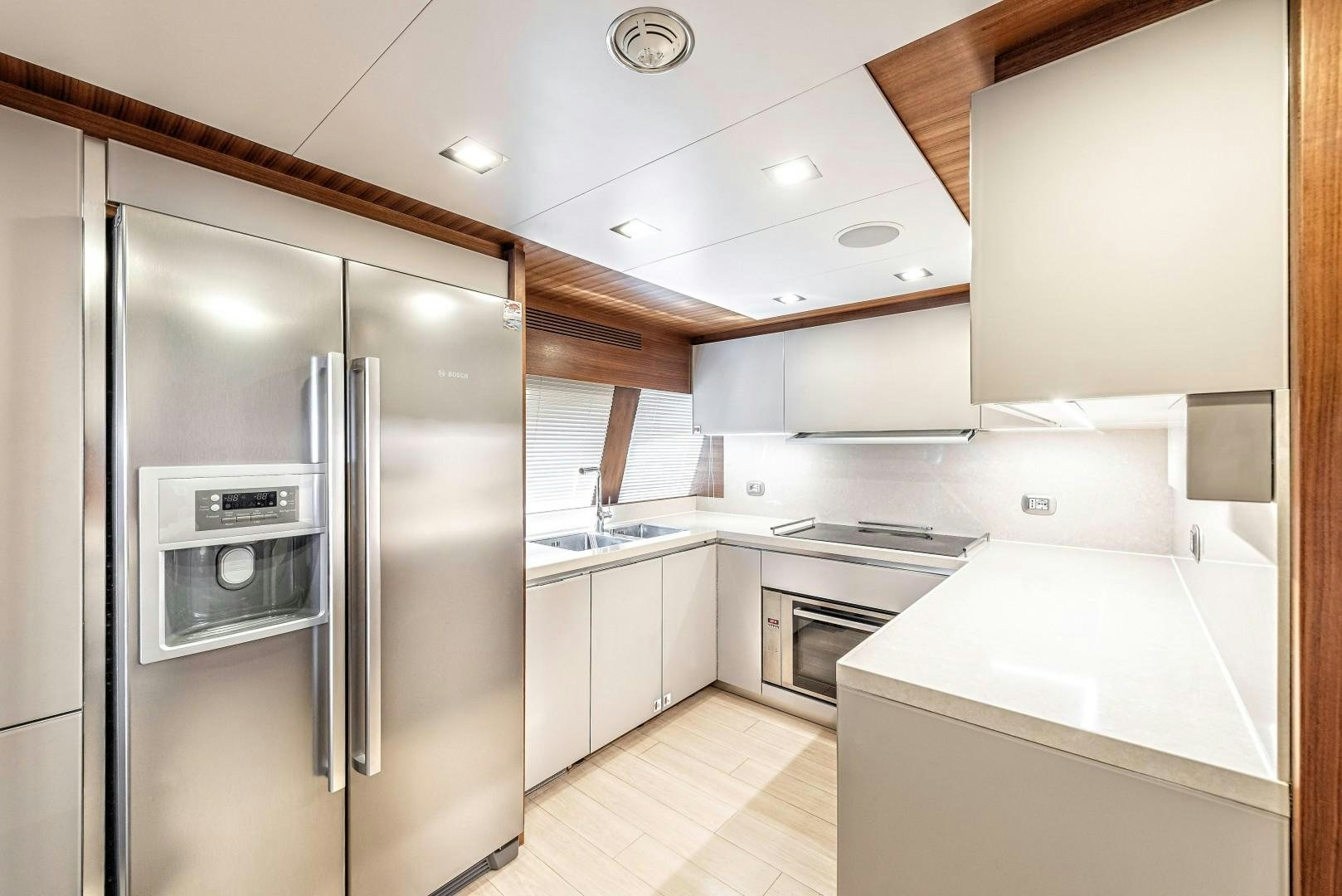a kitchen with a stainless steel refrigerator aboard ARGENTO Yacht for Sale