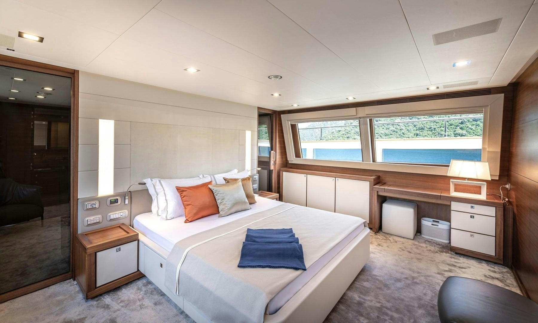 a bedroom with a bed and a desk aboard ARGENTO Yacht for Sale