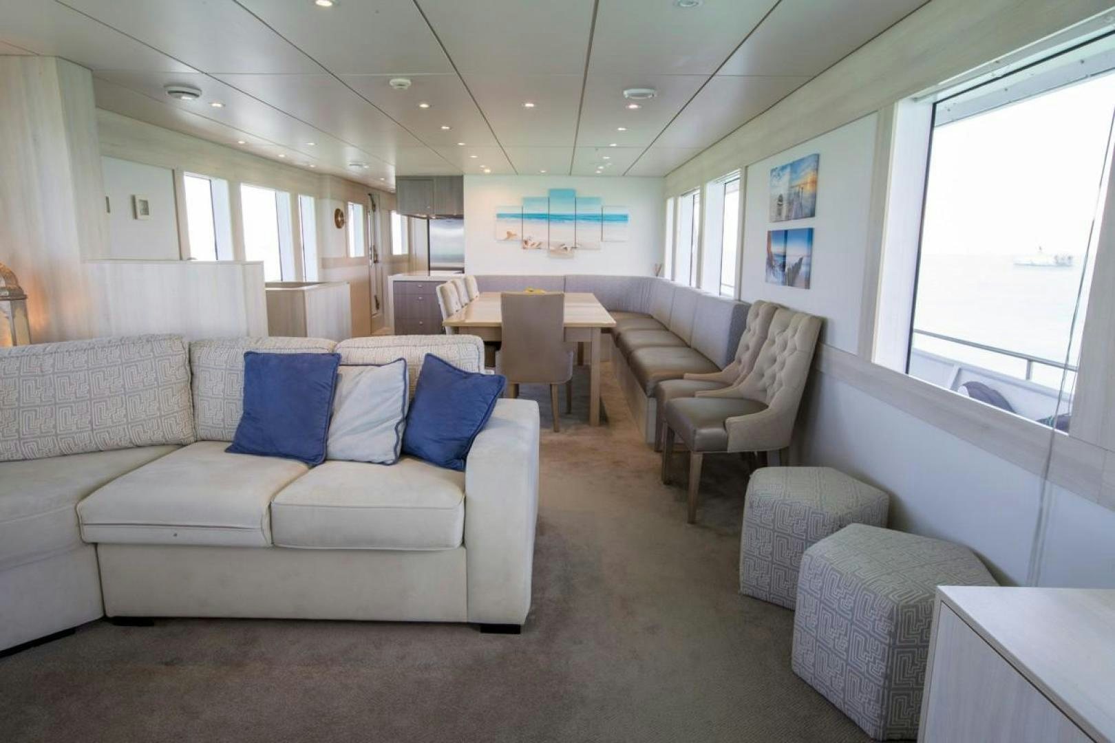 a living room with a couch and chairs aboard KAHU Yacht for Sale