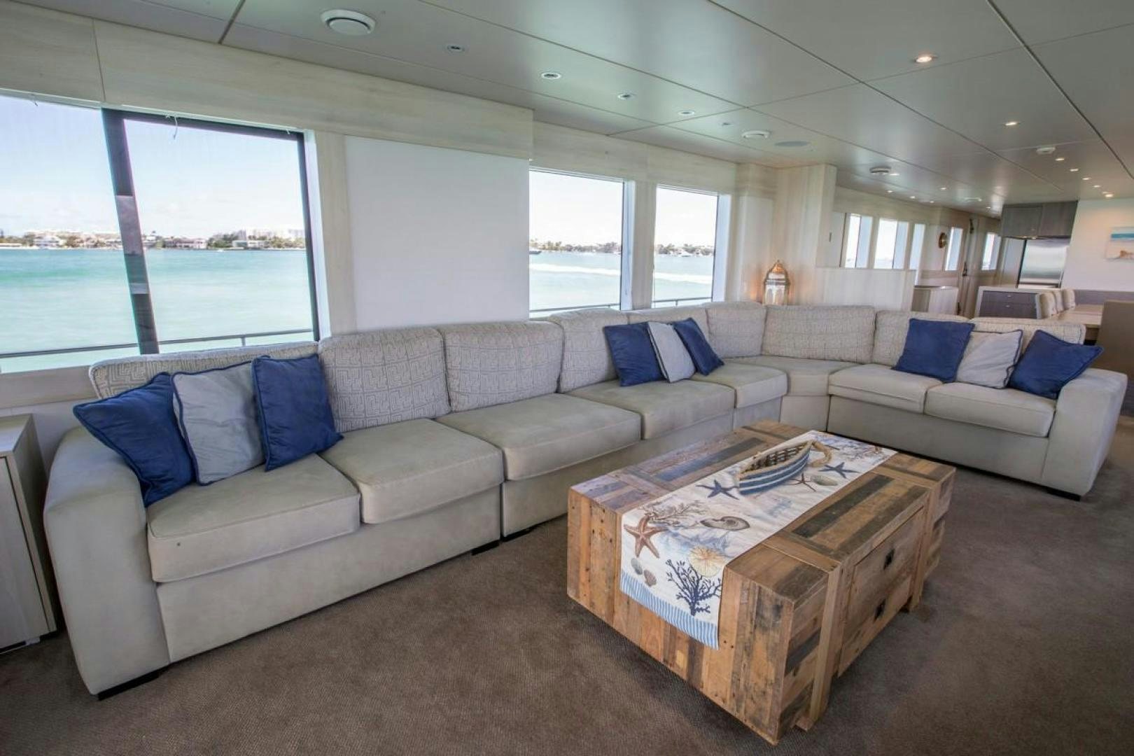 a living room with a couch and a coffee table aboard KAHU Yacht for Sale