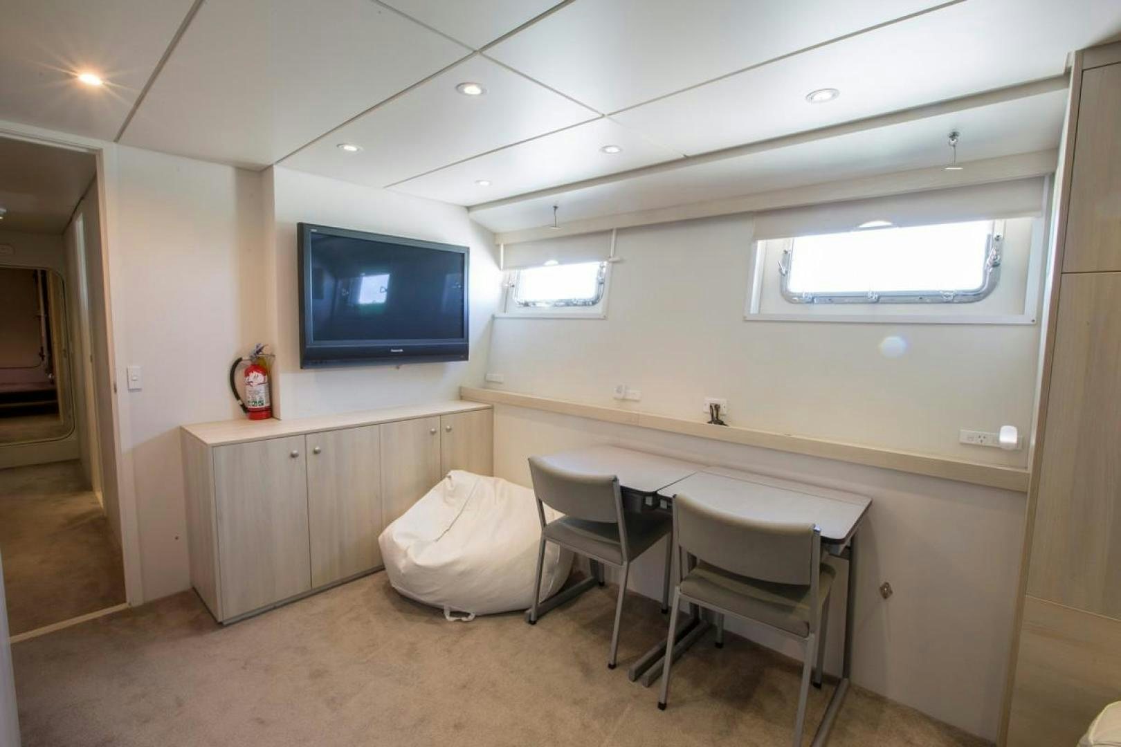a room with a table and chairs aboard KAHU Yacht for Sale