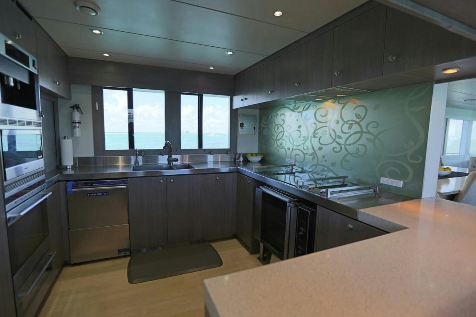 a kitchen with a large island aboard KAHU Yacht for Sale