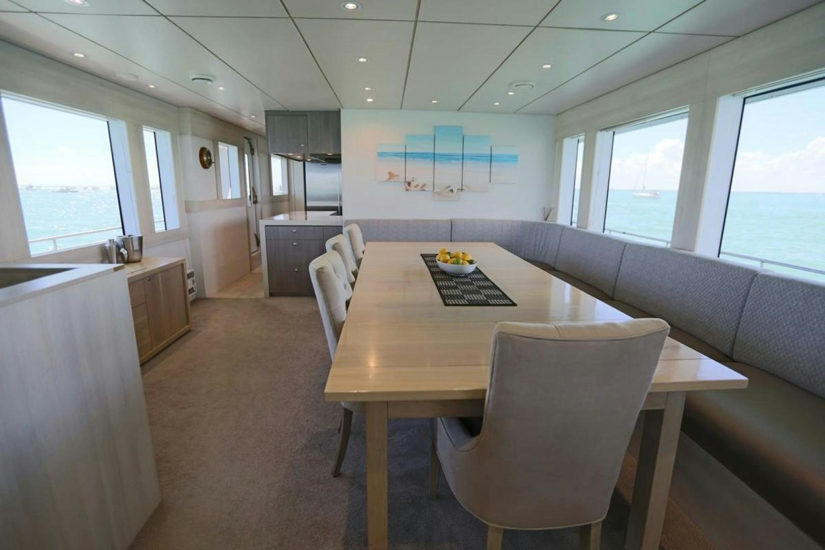 a conference room with a table and chairs aboard KAHU Yacht for Sale