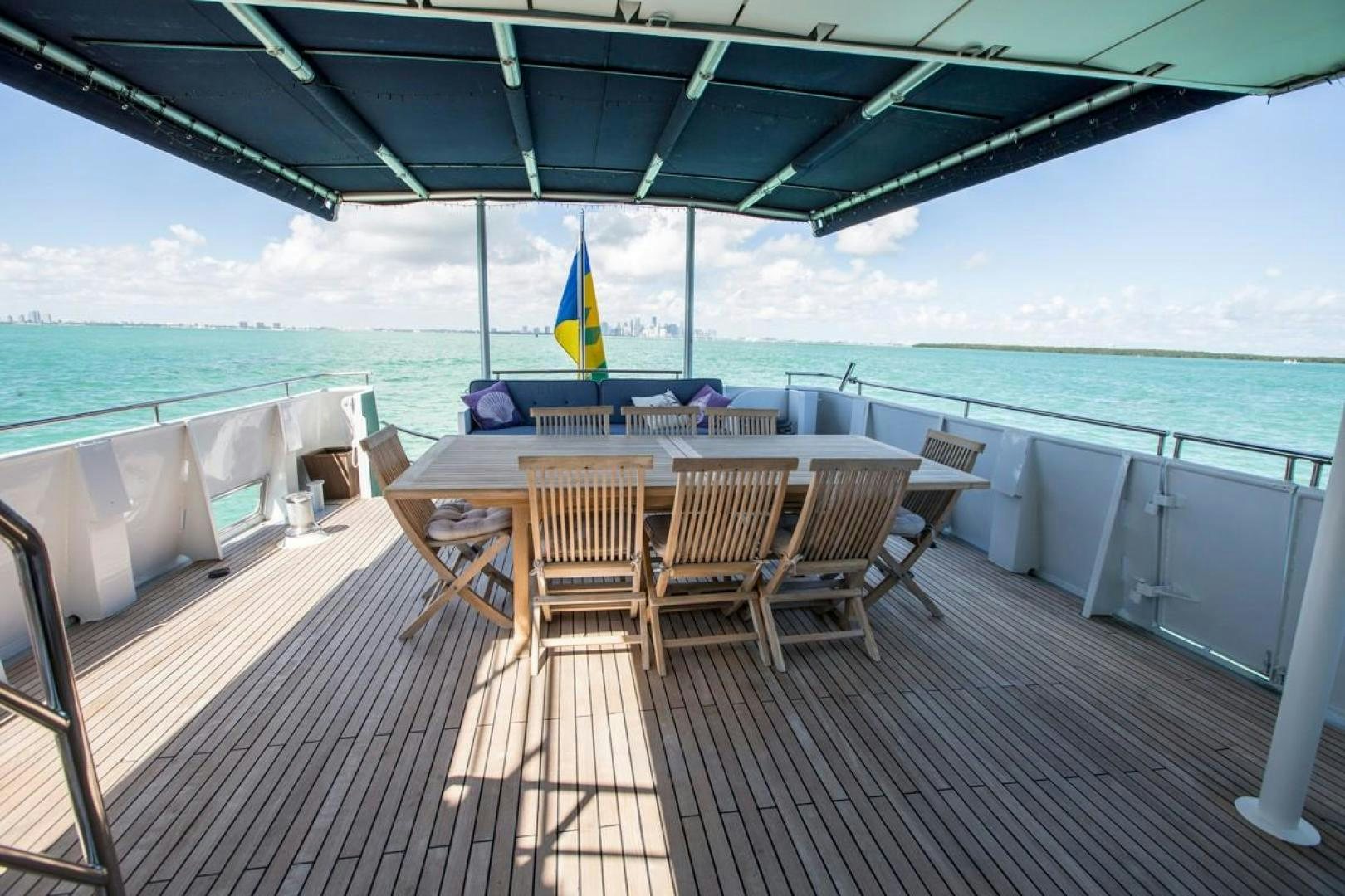 a table and chairs on a deck aboard KAHU Yacht for Sale