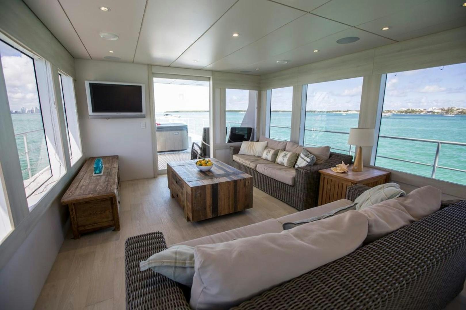 a living room with a large window aboard KAHU Yacht for Sale