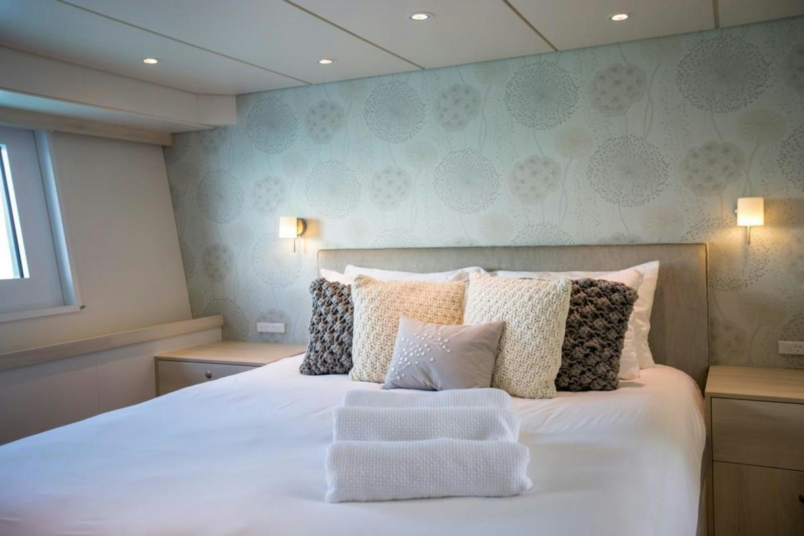 a bed with pillows aboard KAHU Yacht for Sale