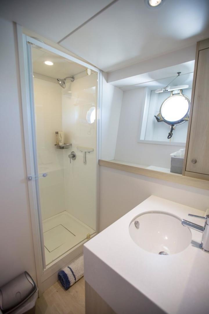 a bathroom with a sink and a mirror aboard KAHU Yacht for Sale