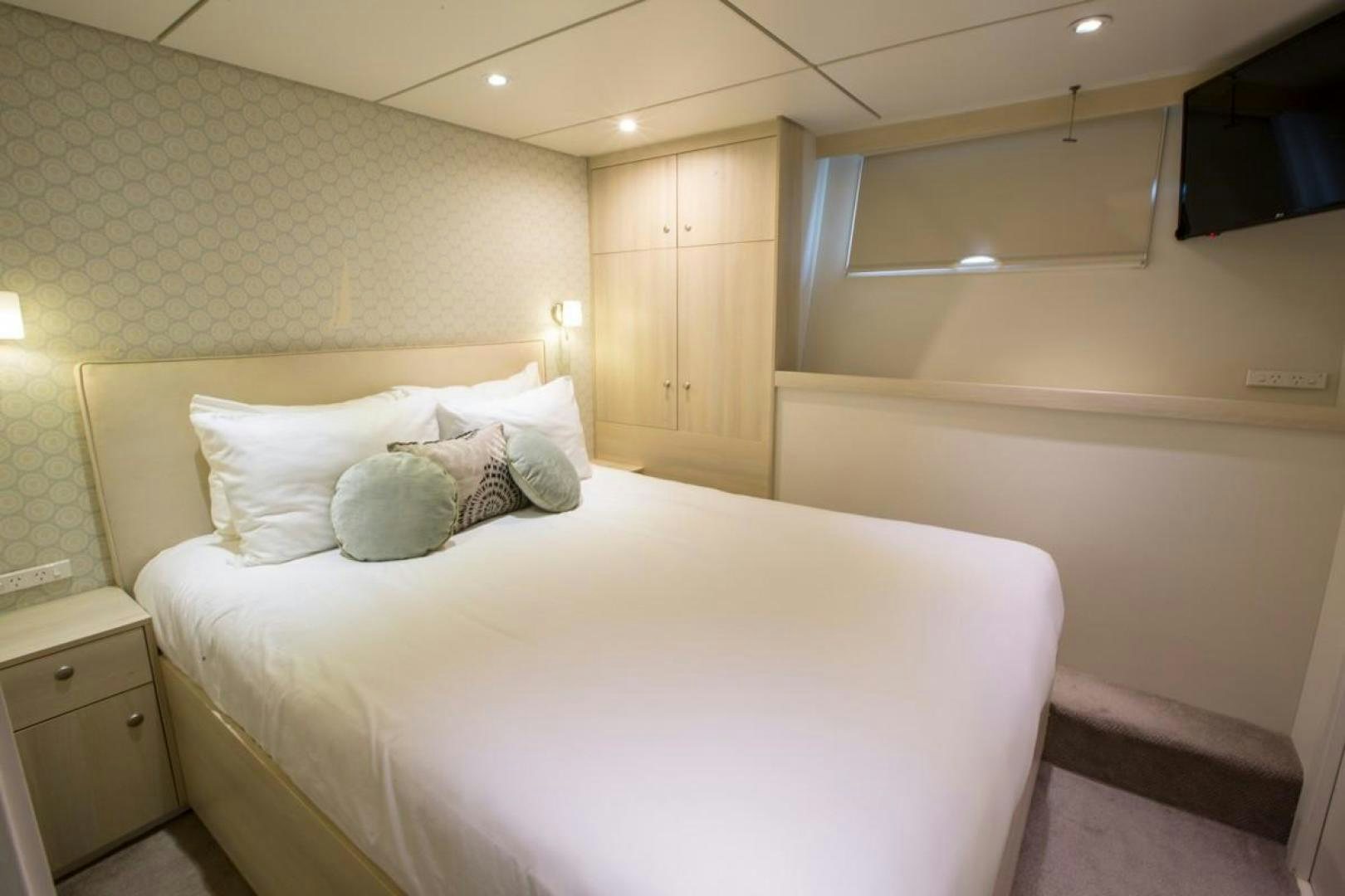 a bed with white sheets aboard KAHU Yacht for Sale