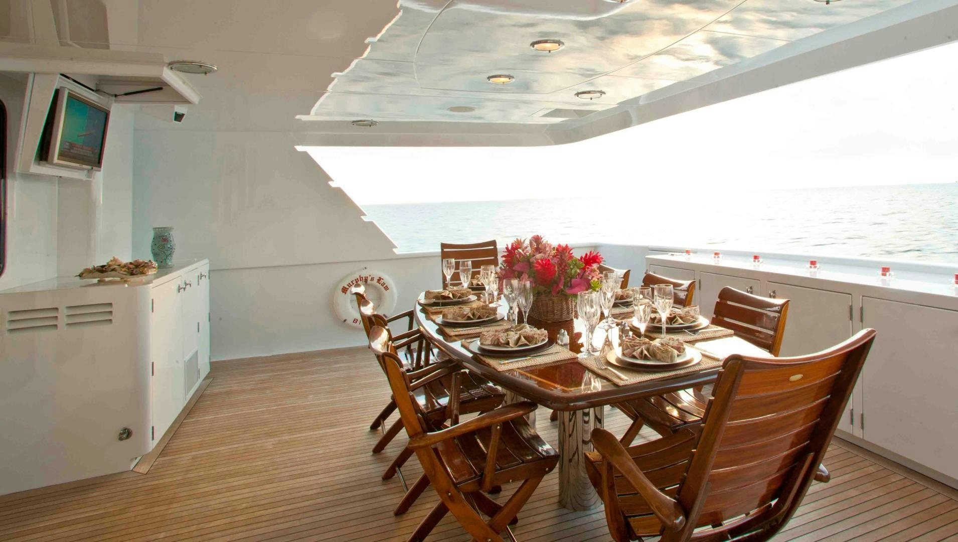 a dining room with a table and chairs aboard MURPHY'S LAW Yacht for Sale