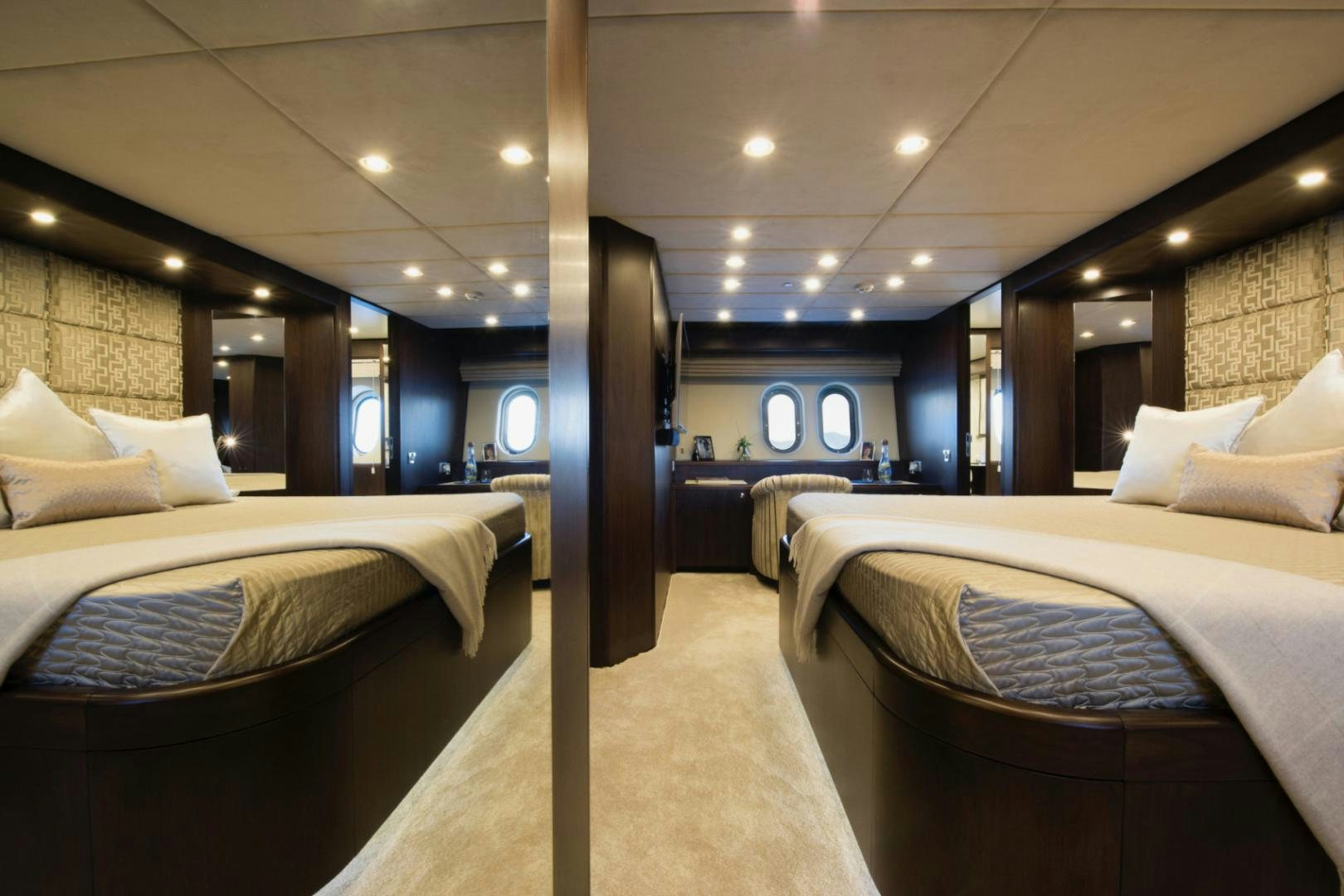 a room with beds and a large mirror aboard CRYSTAL Yacht for Sale