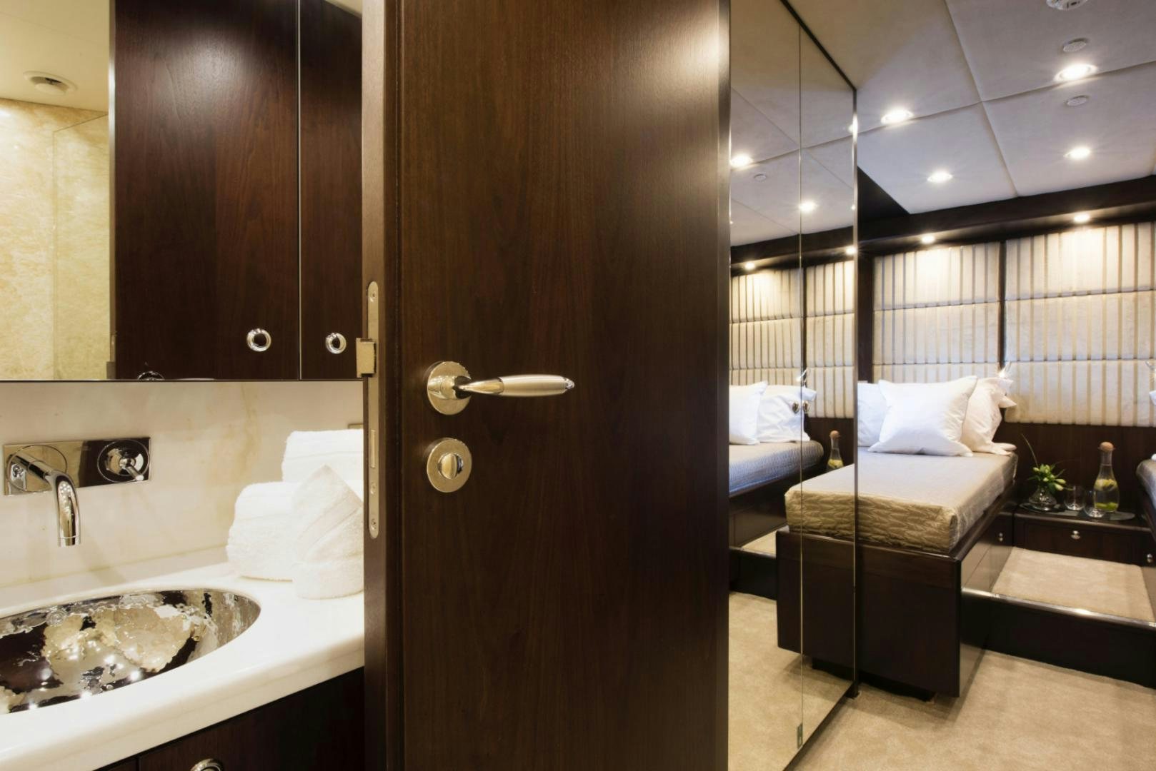 a bathroom with a sink and a bed aboard CRYSTAL Yacht for Sale