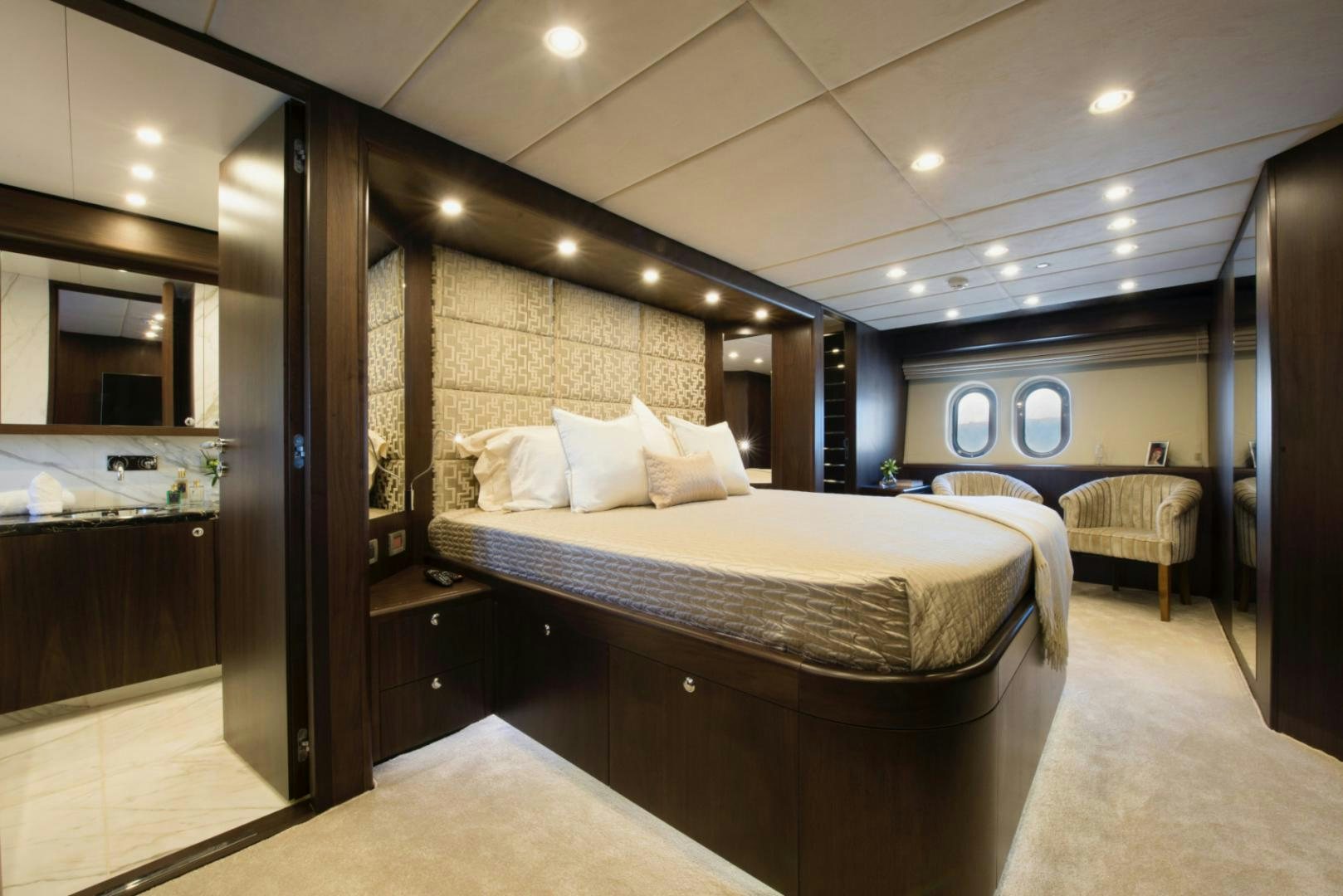 a large bedroom with a large mirror aboard CRYSTAL Yacht for Sale