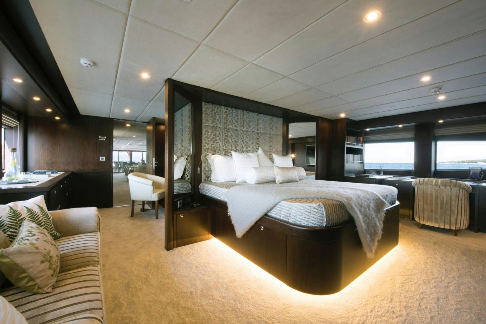 a large room with a bed and a couch aboard CRYSTAL Yacht for Sale