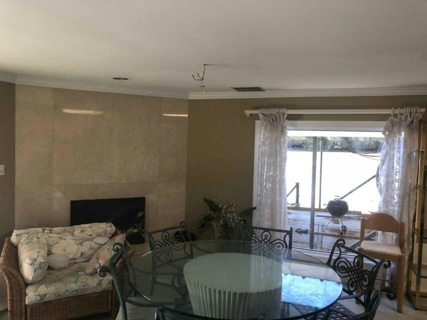 a living room with a fireplace aboard LAKEHOUSE Yacht for Sale