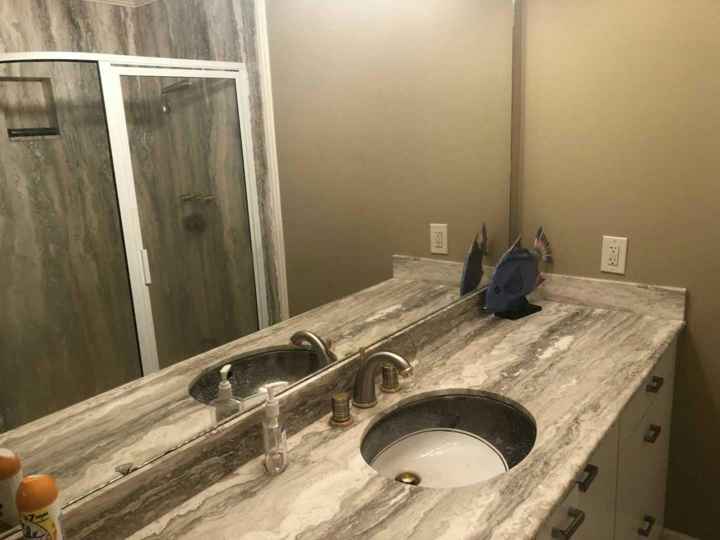 a bathroom with a sink and a large mirror aboard LAKEHOUSE Yacht for Sale