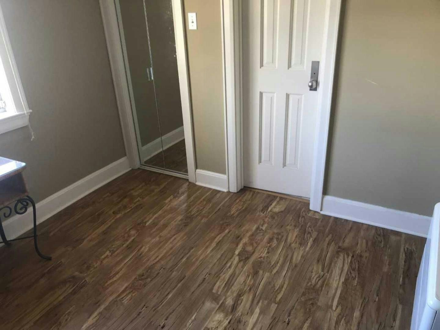 a room with a wood floor and white doors aboard LAKEHOUSE Yacht for Sale