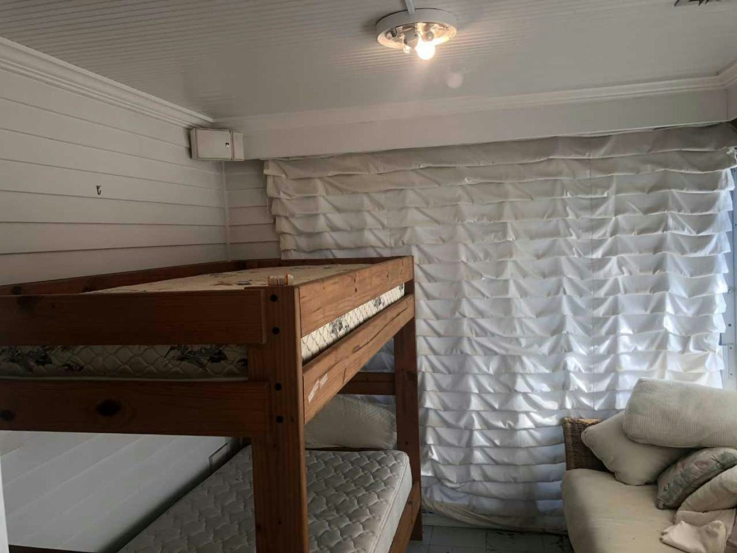 a room with a bed and a couch aboard LAKEHOUSE Yacht for Sale