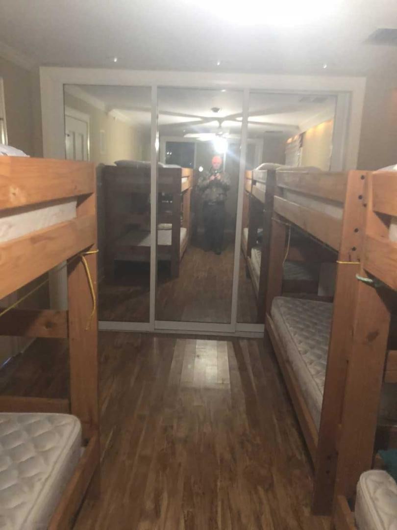 a room with wooden floors and wood cabinets aboard LAKEHOUSE Yacht for Sale