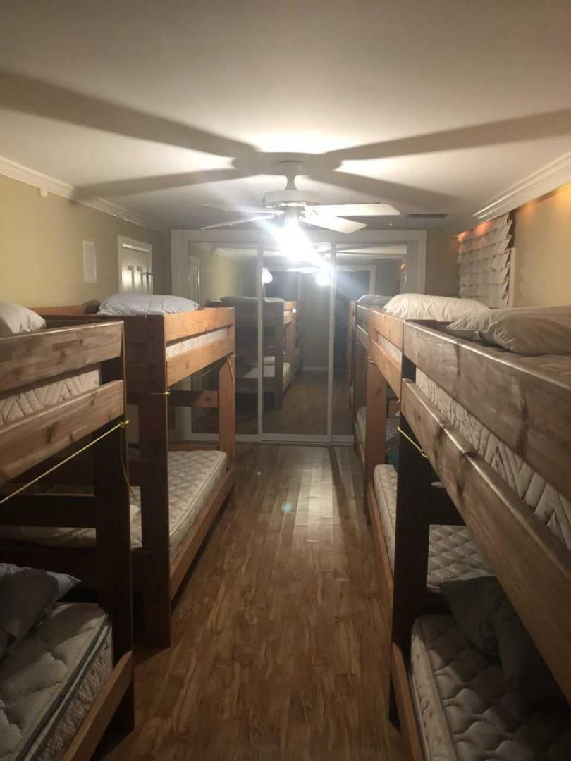 a room with a bed and a wood floor aboard LAKEHOUSE Yacht for Sale