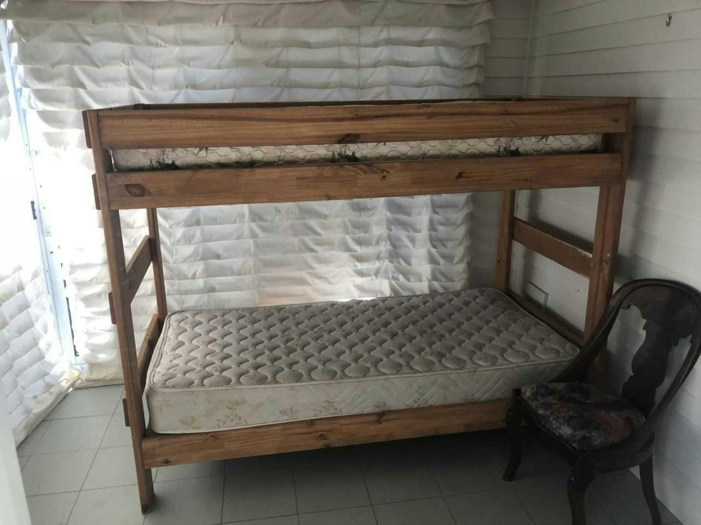 a wooden bench with a chair aboard LAKEHOUSE Yacht for Sale