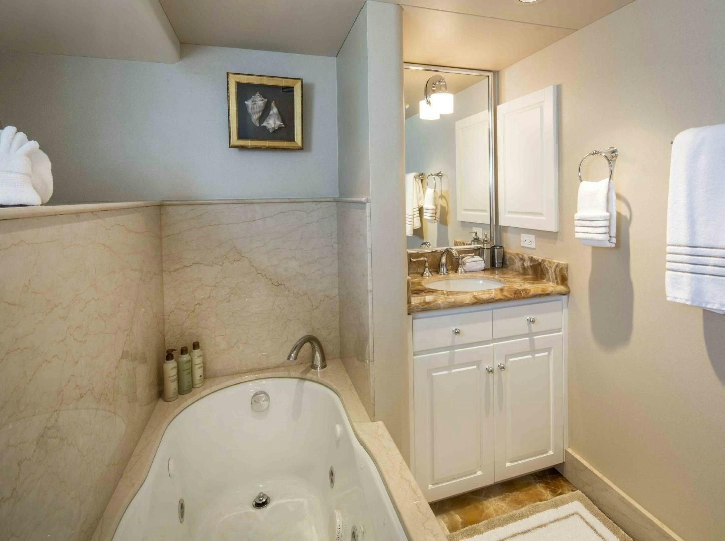 a bathroom with a tub sink and mirror aboard CHERISH Yacht for Sale