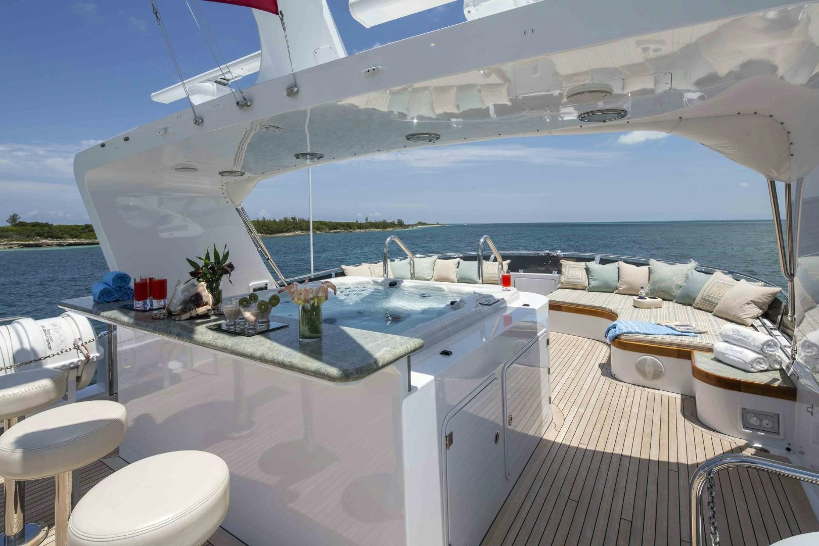 a large white room with a large pool and a deck with a view of the ocean aboard CHERISH Yacht for Sale