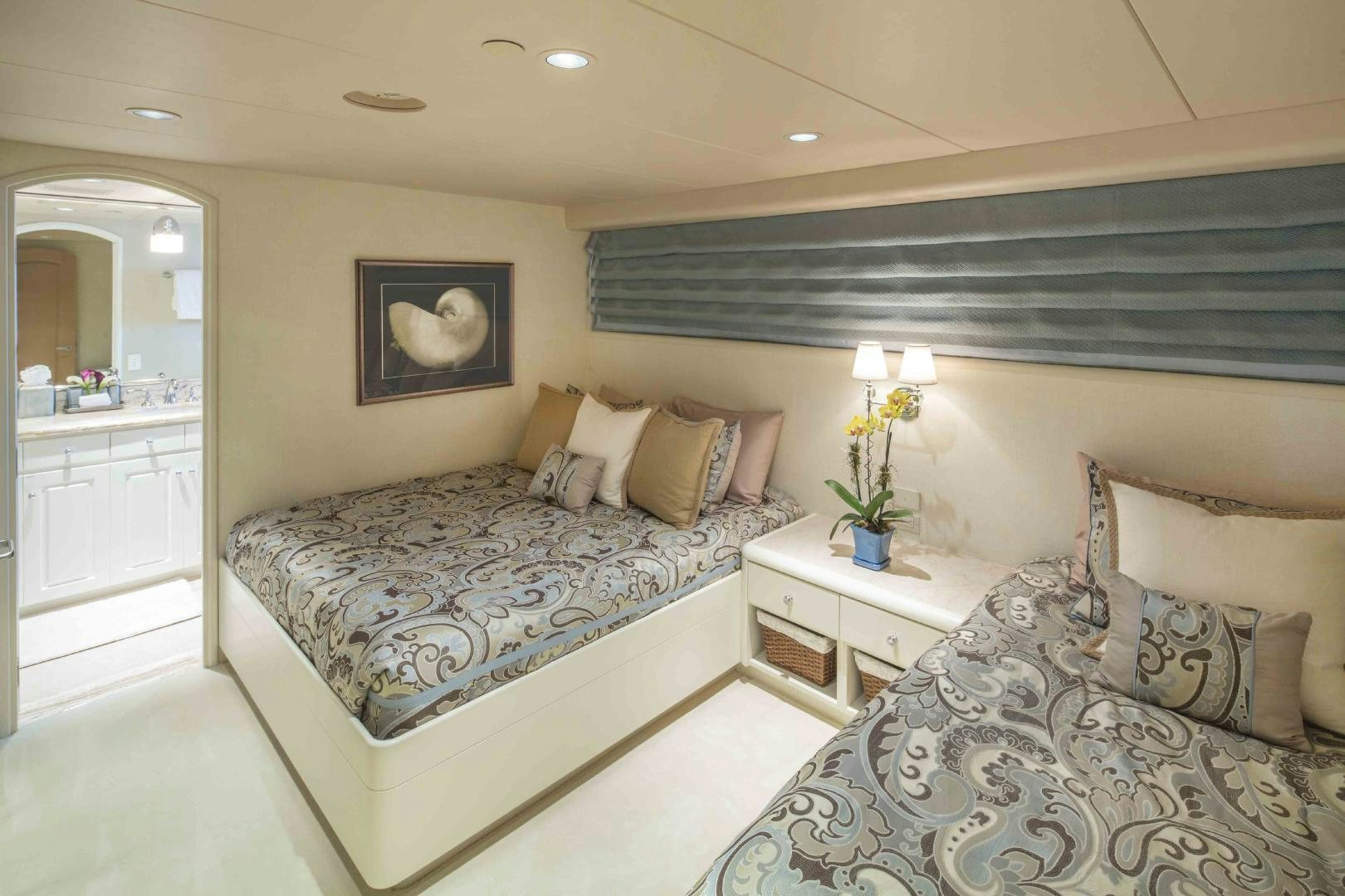 a bedroom with a bed and a large mirror aboard CHERISH Yacht for Sale