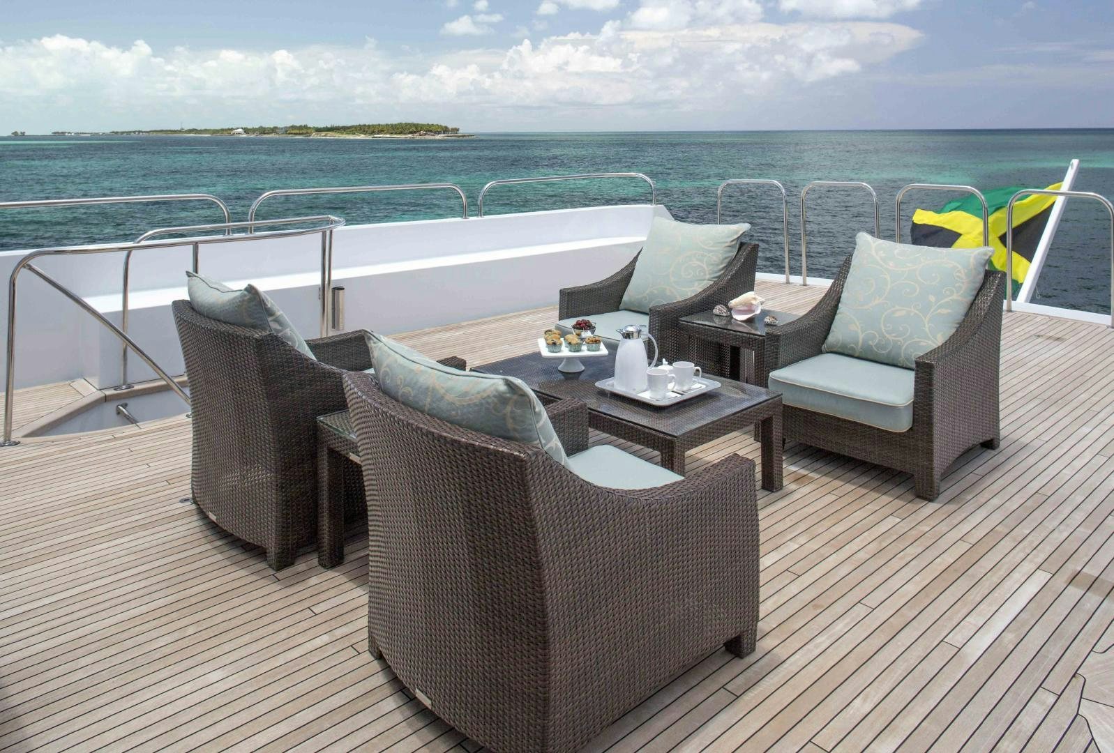a deck with chairs and a table on it aboard CHERISH Yacht for Sale