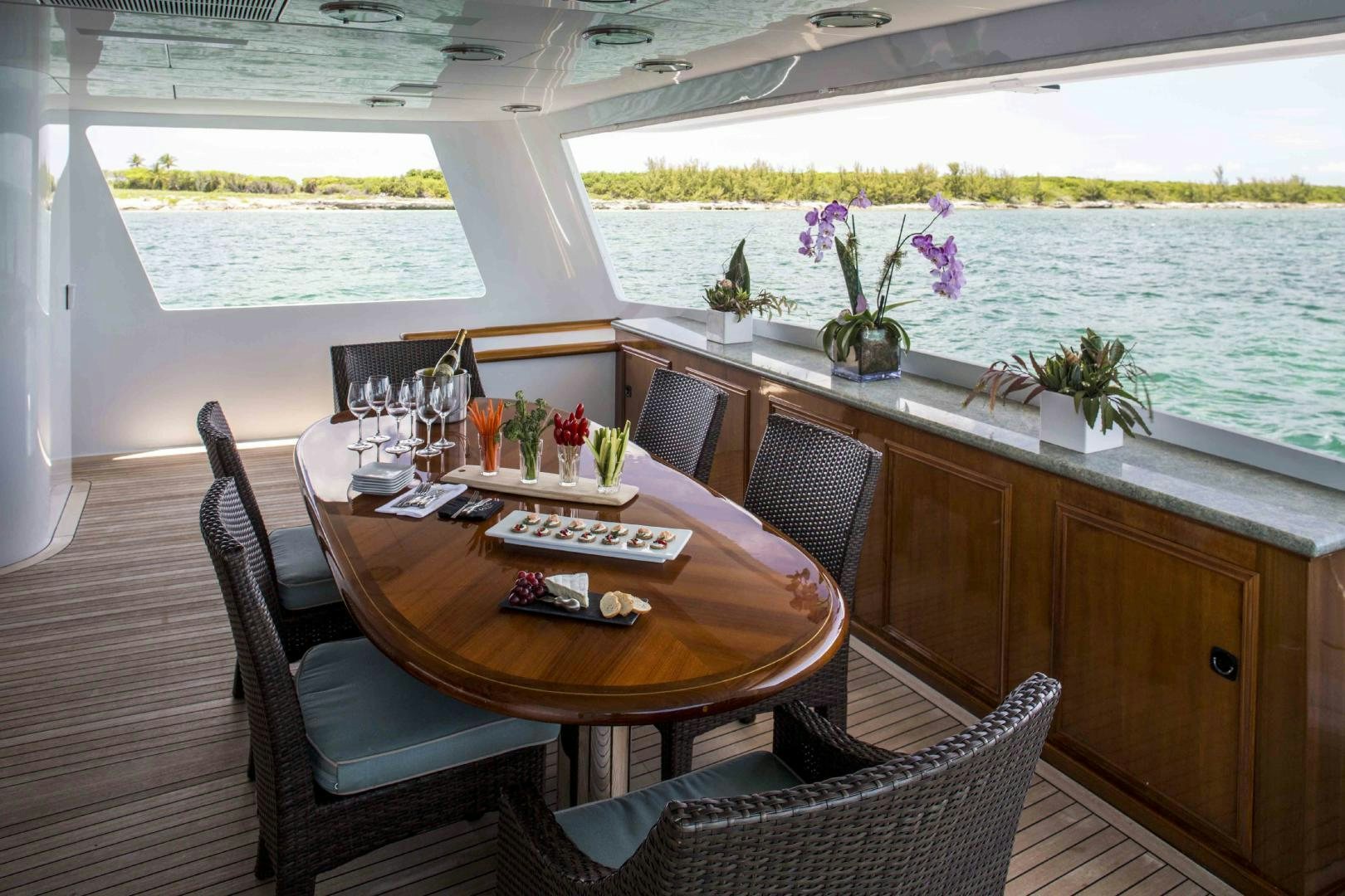 a table and chairs on a balcony aboard CHERISH Yacht for Sale