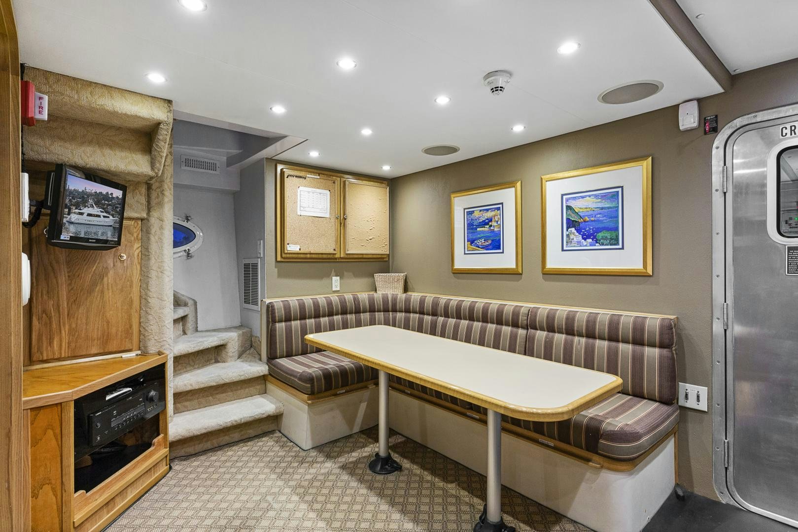a room with a table and couch aboard ISABELLA Yacht for Sale