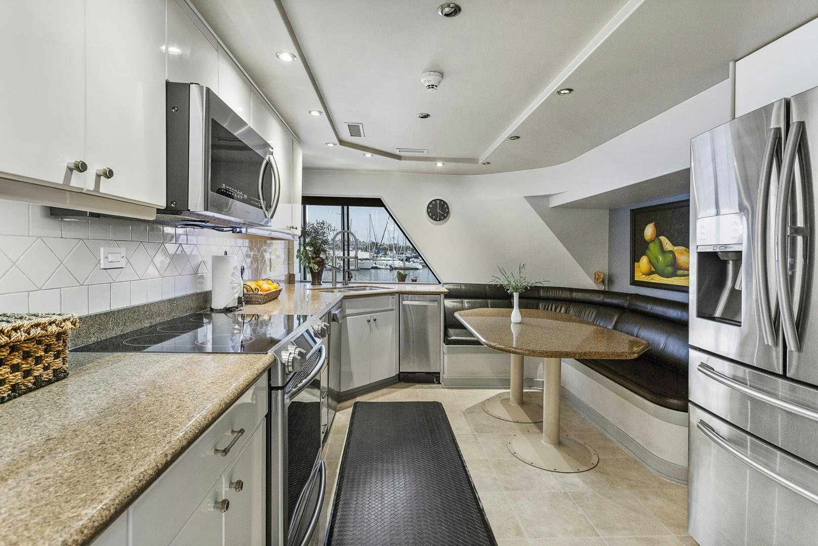 a kitchen with a table and refrigerator aboard ISABELLA Yacht for Sale