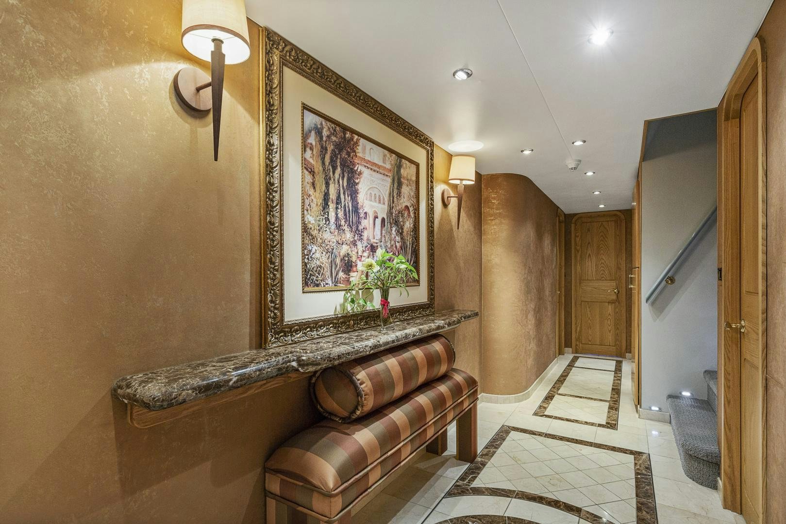 a room with a bench and a painting on the wall aboard ISABELLA Yacht for Sale