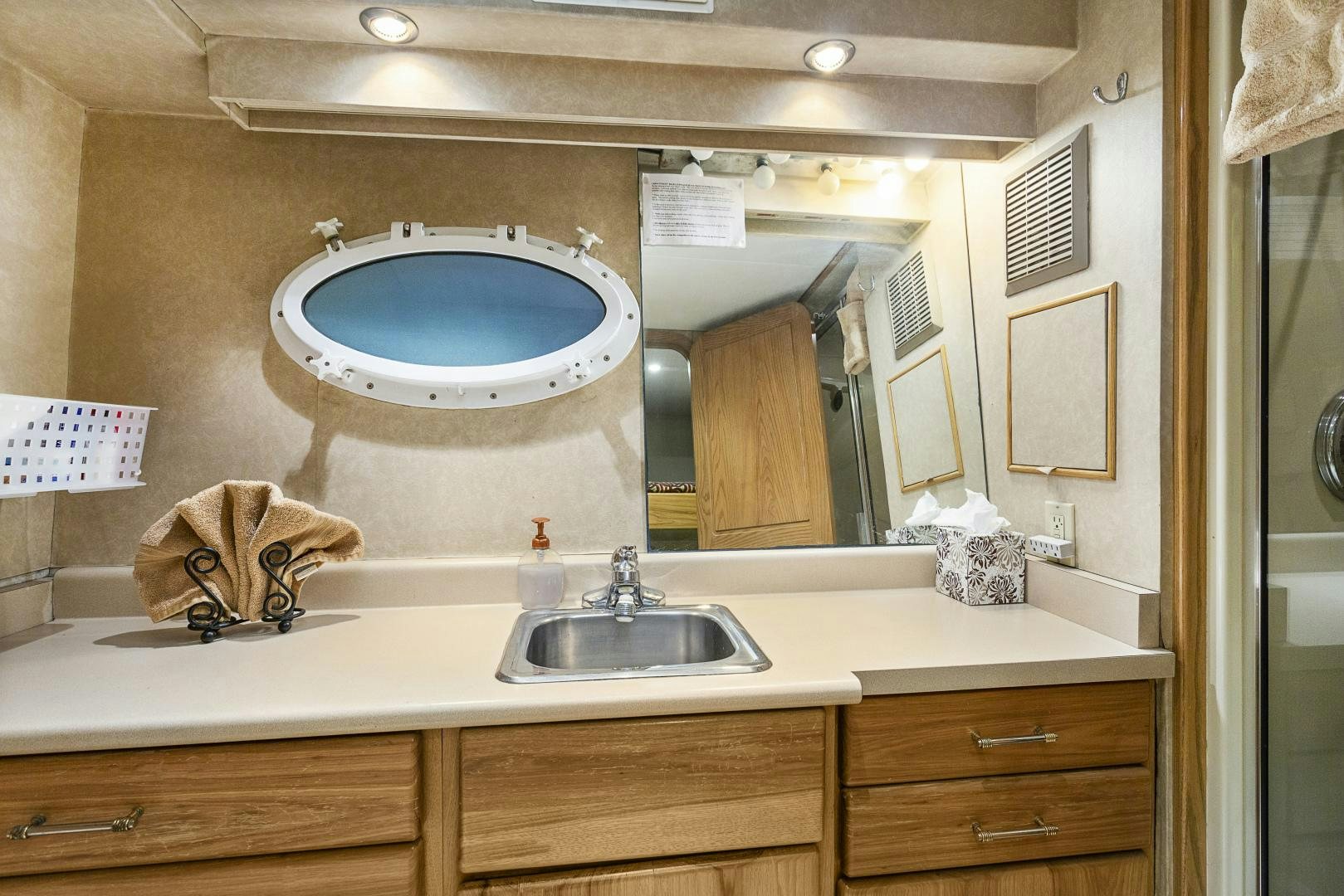a bathroom with a large round mirror aboard ISABELLA Yacht for Sale