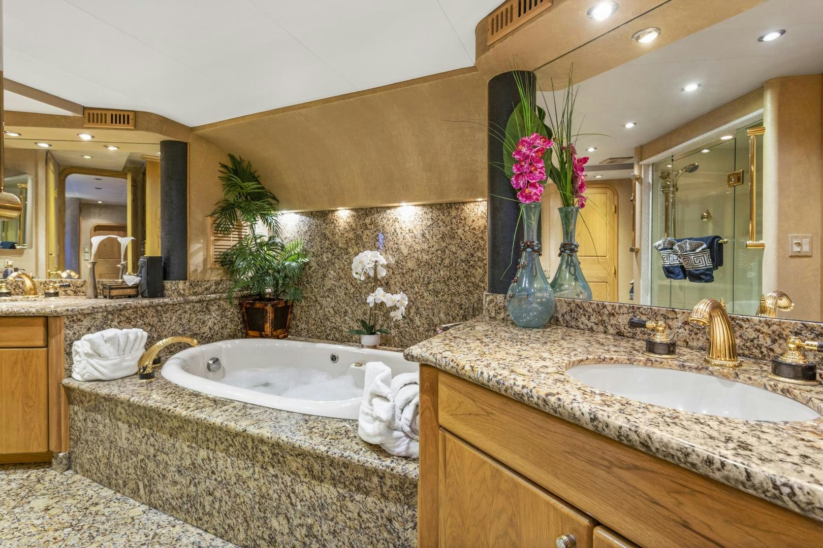 a bathroom with a large marble countertop and a large mirror aboard ISABELLA Yacht for Sale