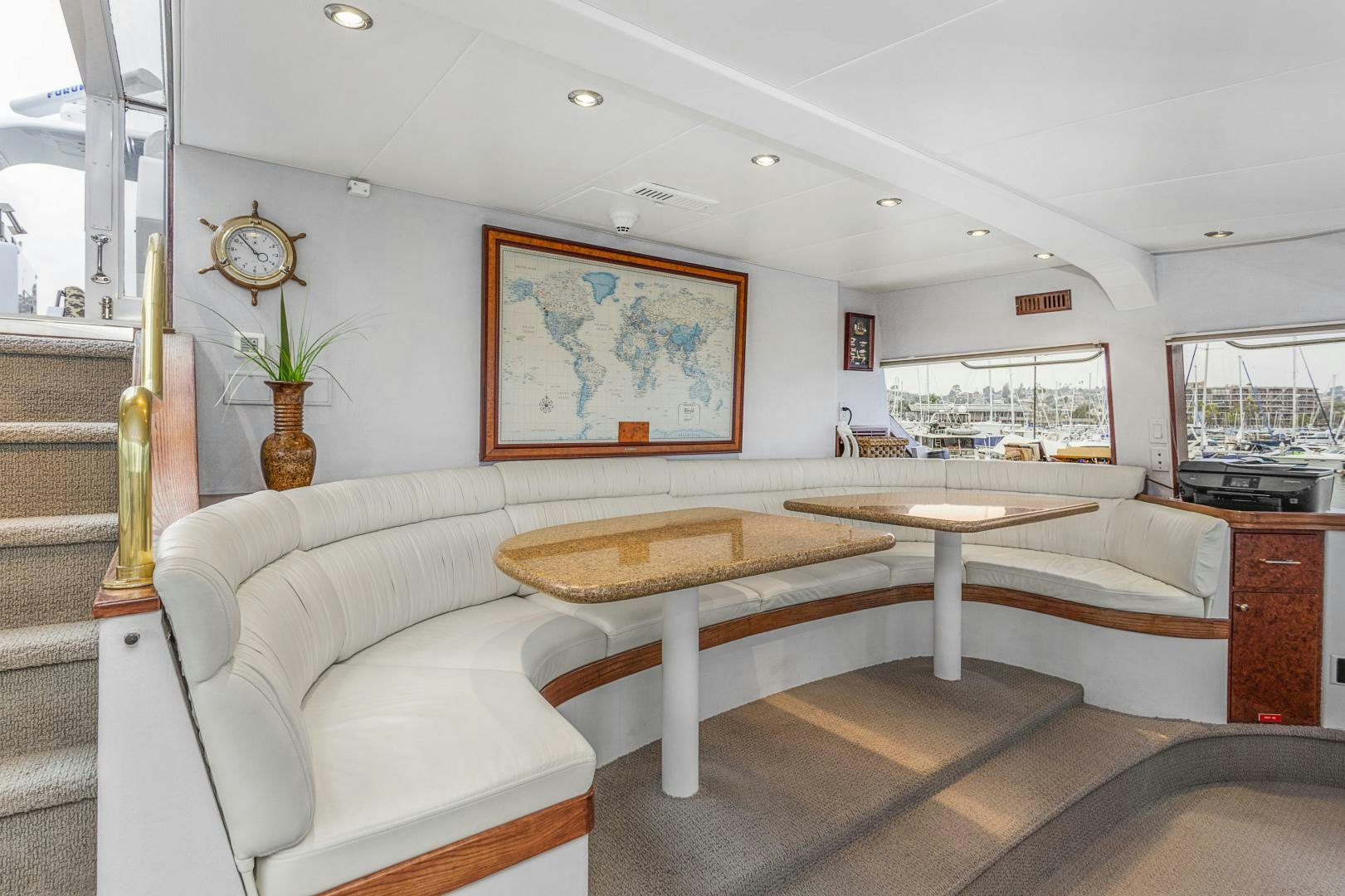 a living room with a large table and couches aboard ISABELLA Yacht for Sale