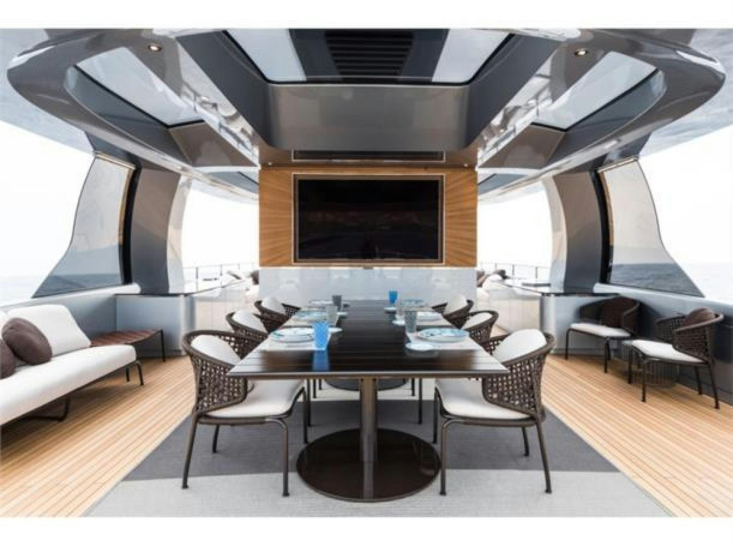 a room with a table and chairs aboard GTT 115 HYBRID Yacht for Sale