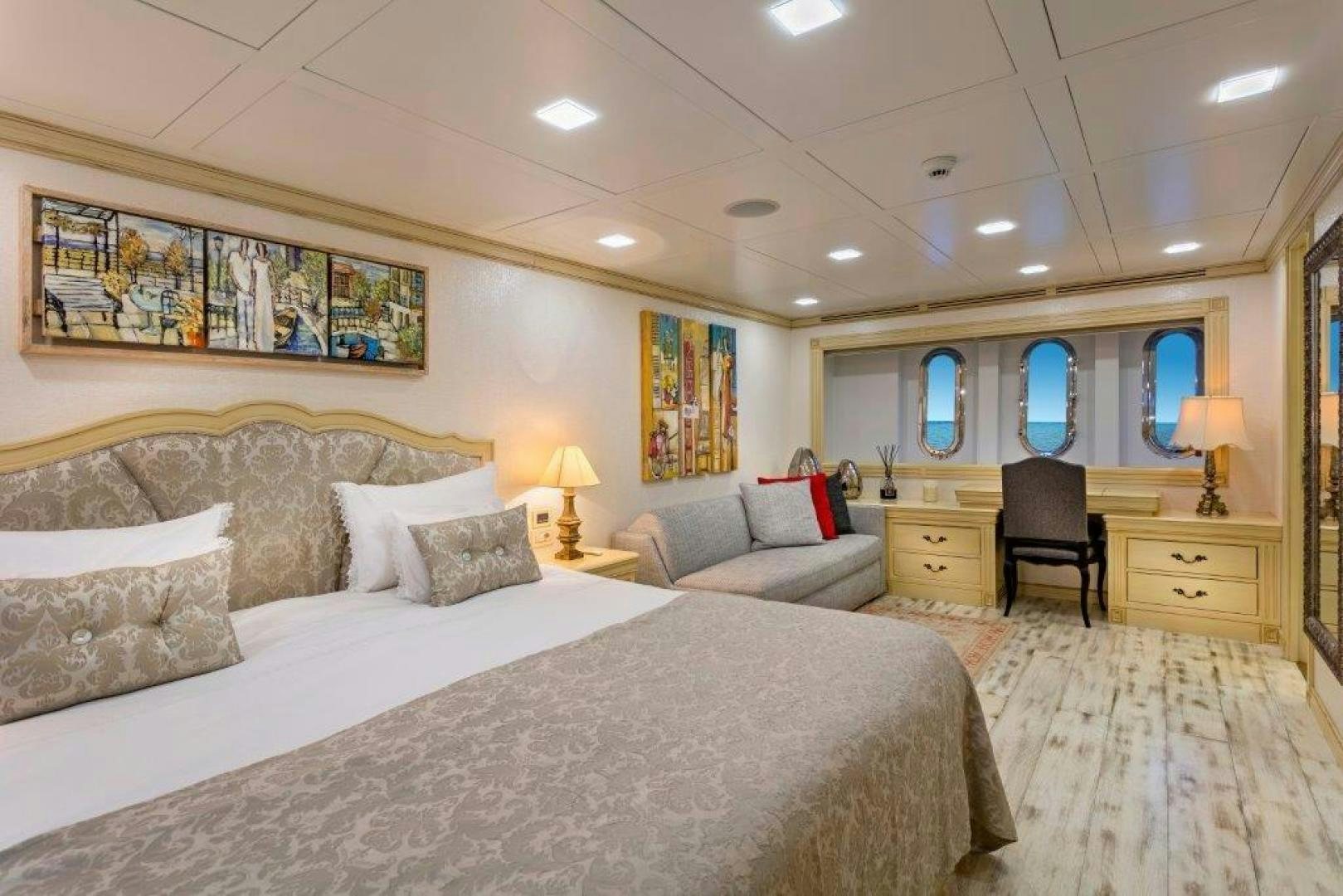 a bedroom with a large bed aboard M&M Yacht for Sale