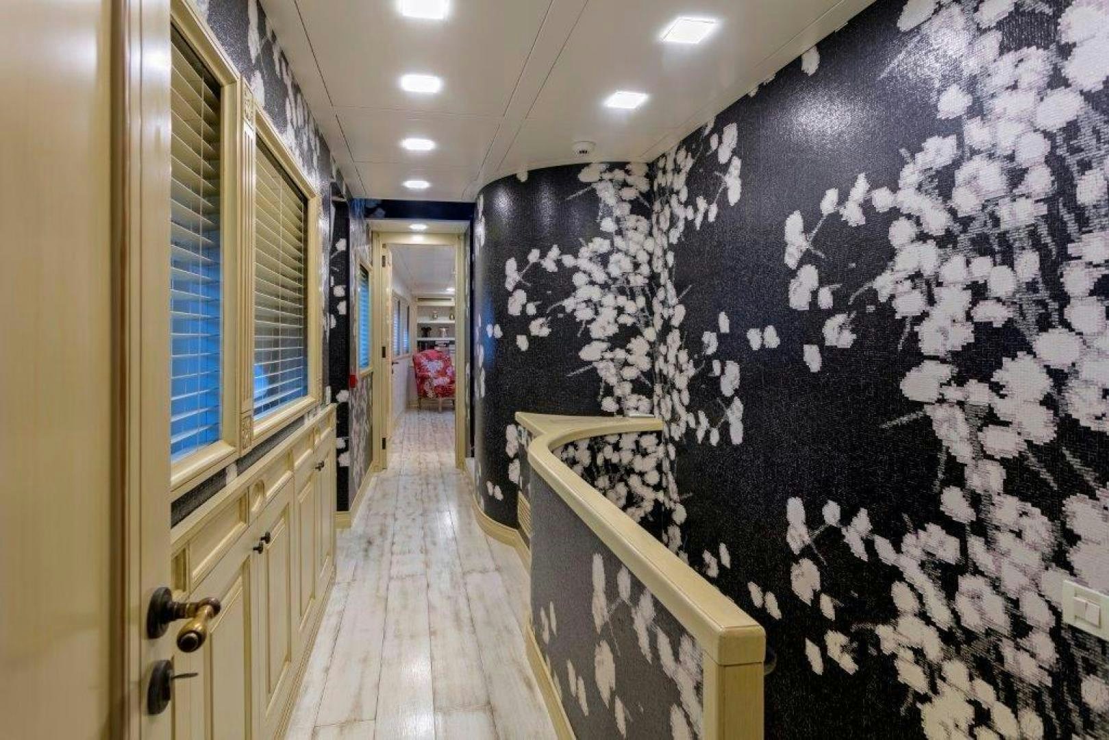 a hallway with a wall of art aboard M&M Yacht for Sale