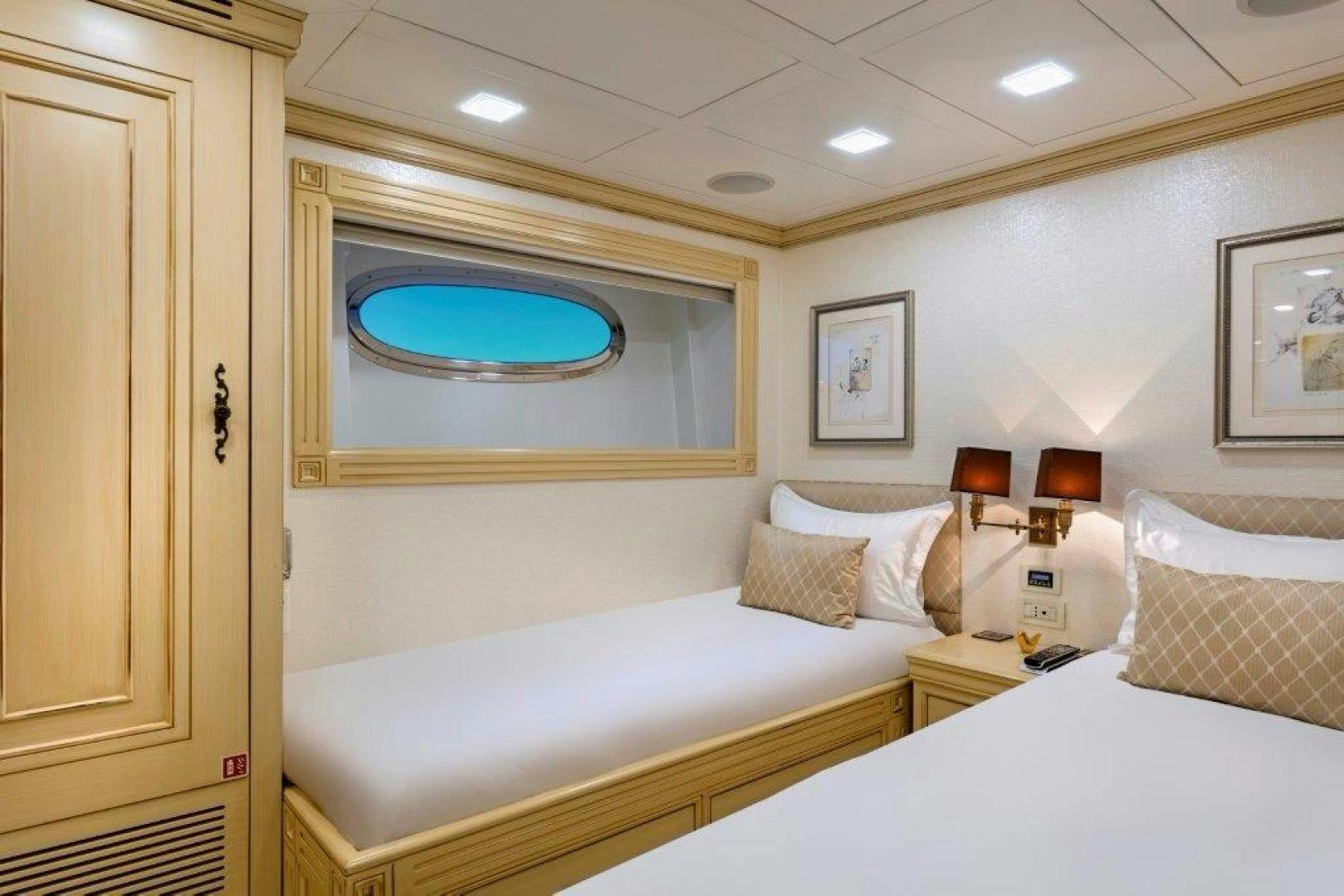 a room with two beds aboard M&M Yacht for Sale