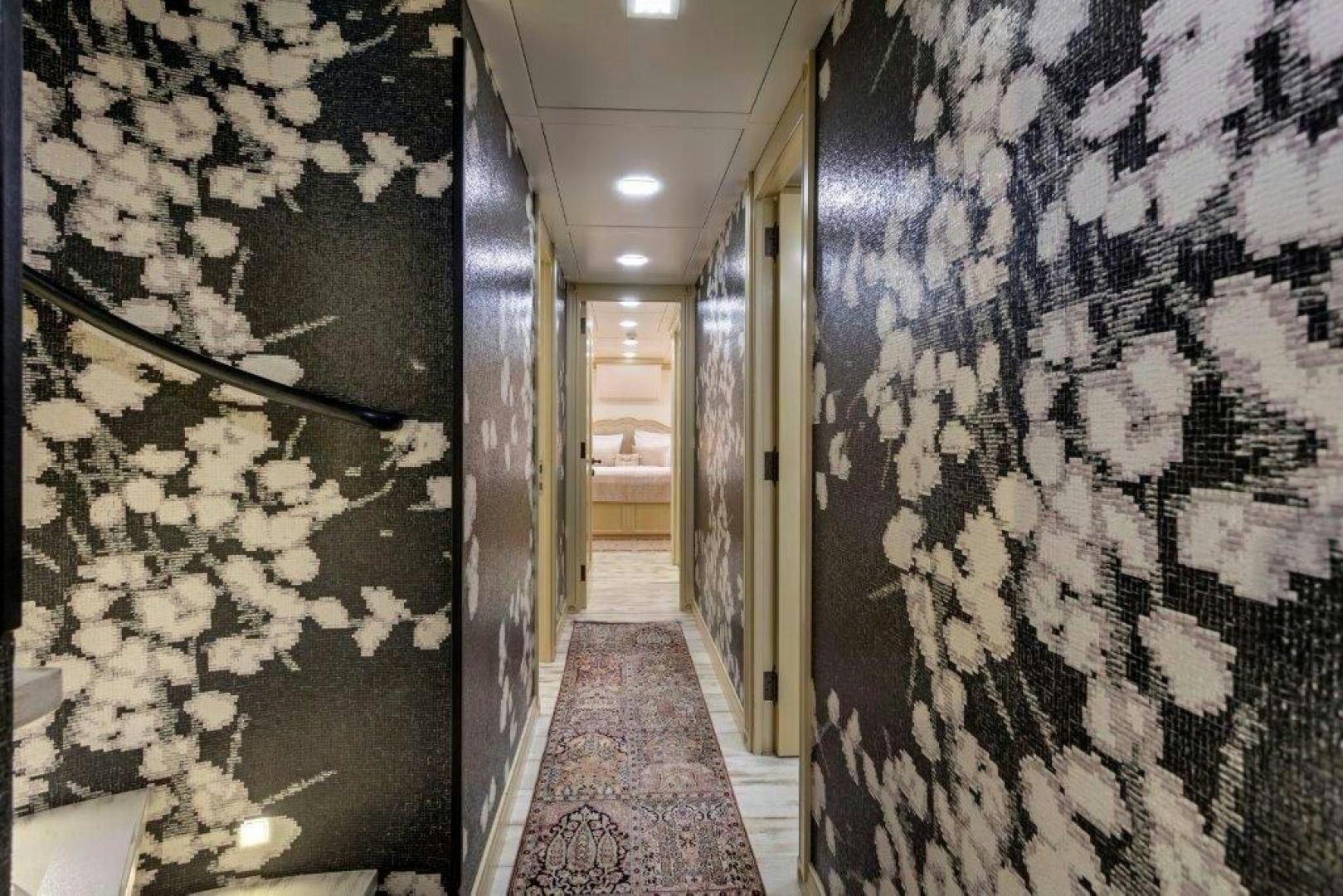 a hallway with a wall of art aboard M&M Yacht for Sale