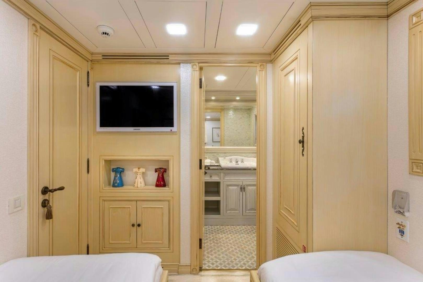 a room with a bed and a television aboard M&M Yacht for Sale