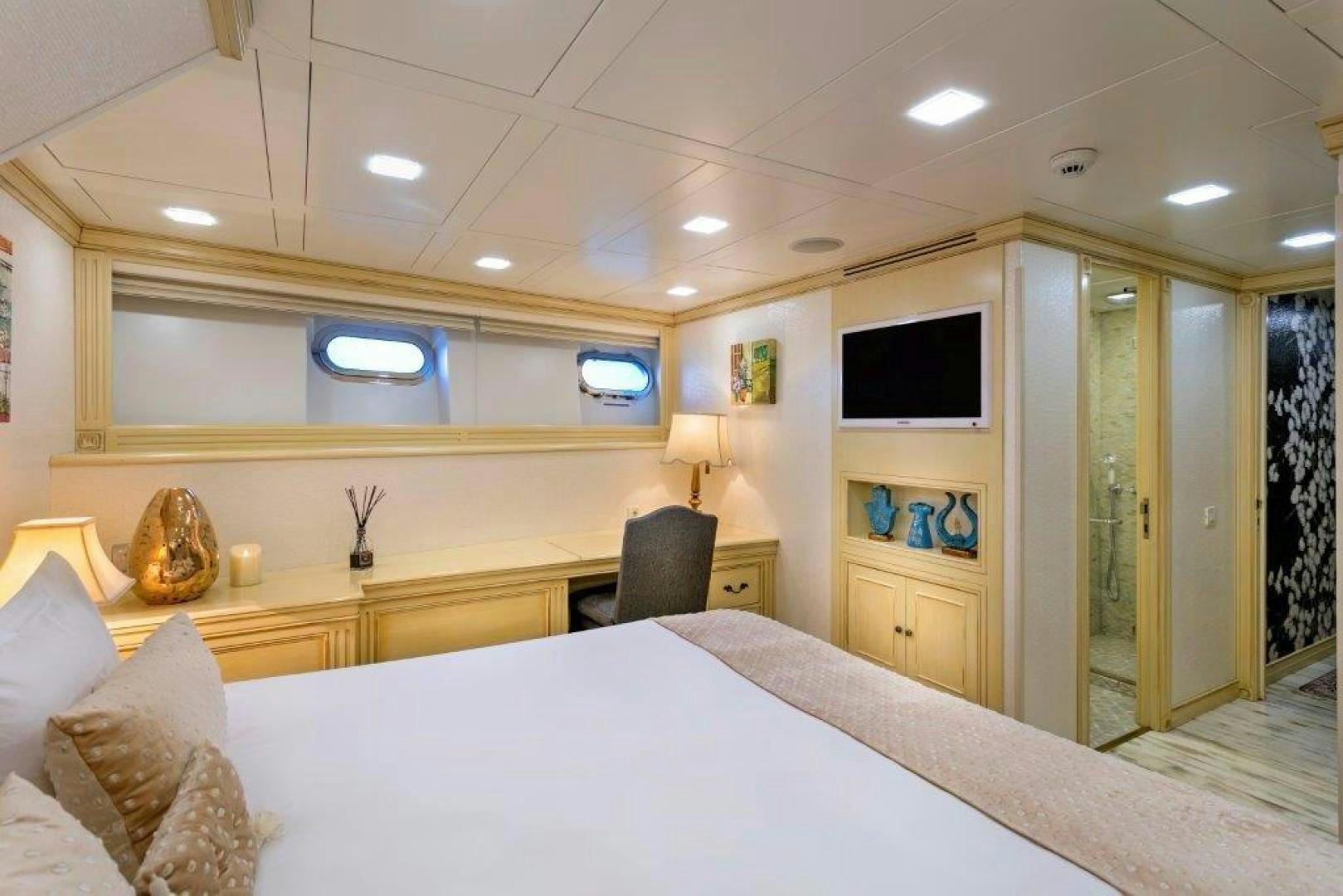 a room with a bed and a tv on the wall aboard M&M Yacht for Sale