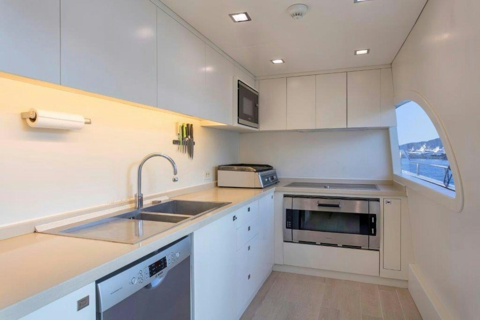 a kitchen with white cabinets aboard M&M Yacht for Sale